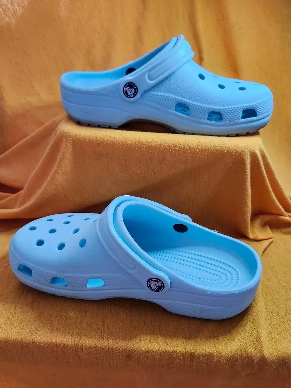 Crocs Classic clogs feature the iconic ventilated design and a swivel heel strap